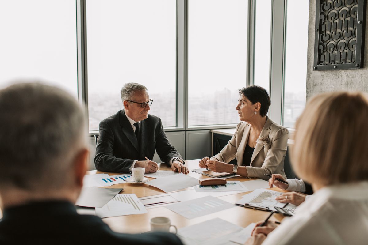 Deal advisory team negotiating a transaction in a boardroom