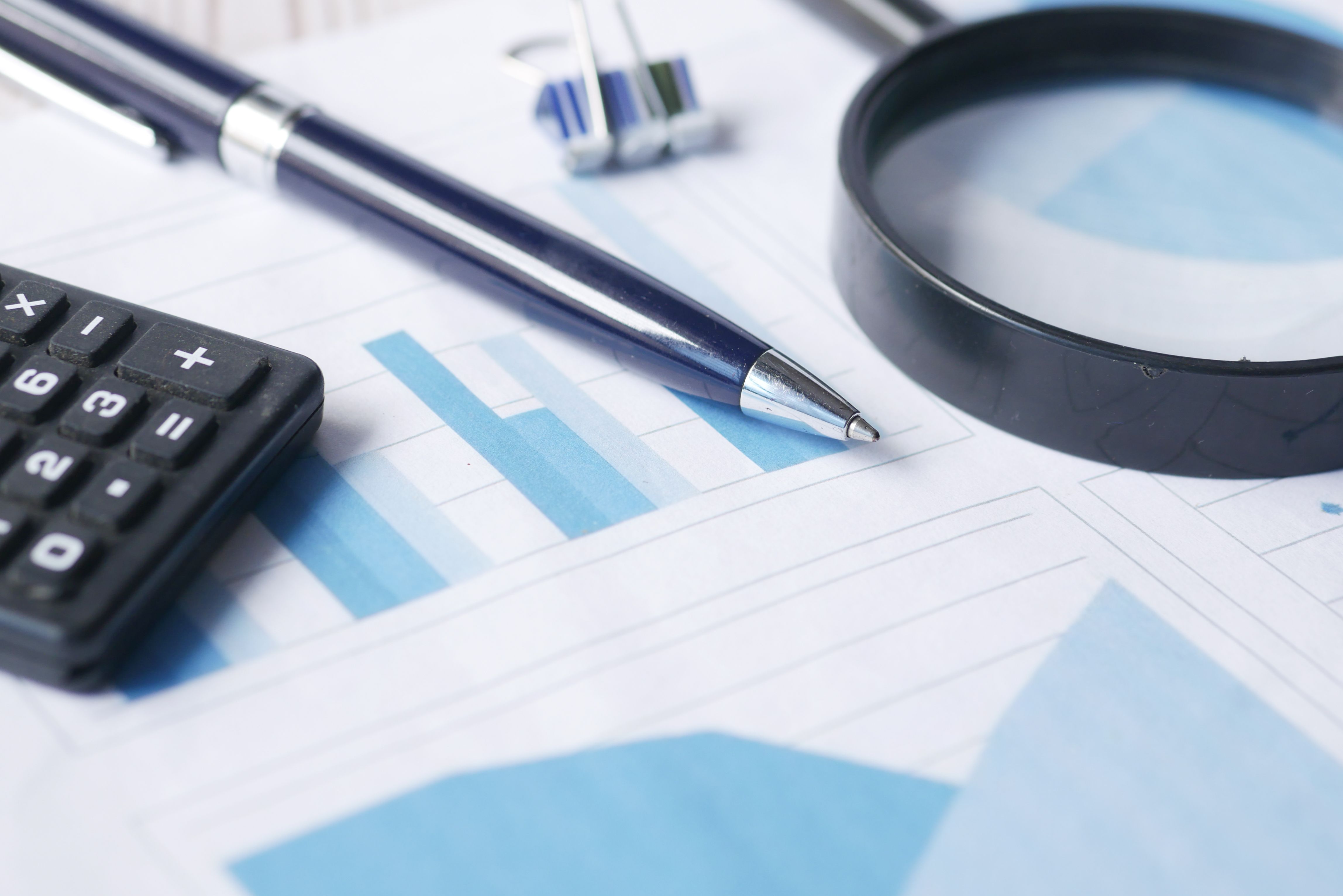 Magnifying glass and calculator for risk-based due diligence