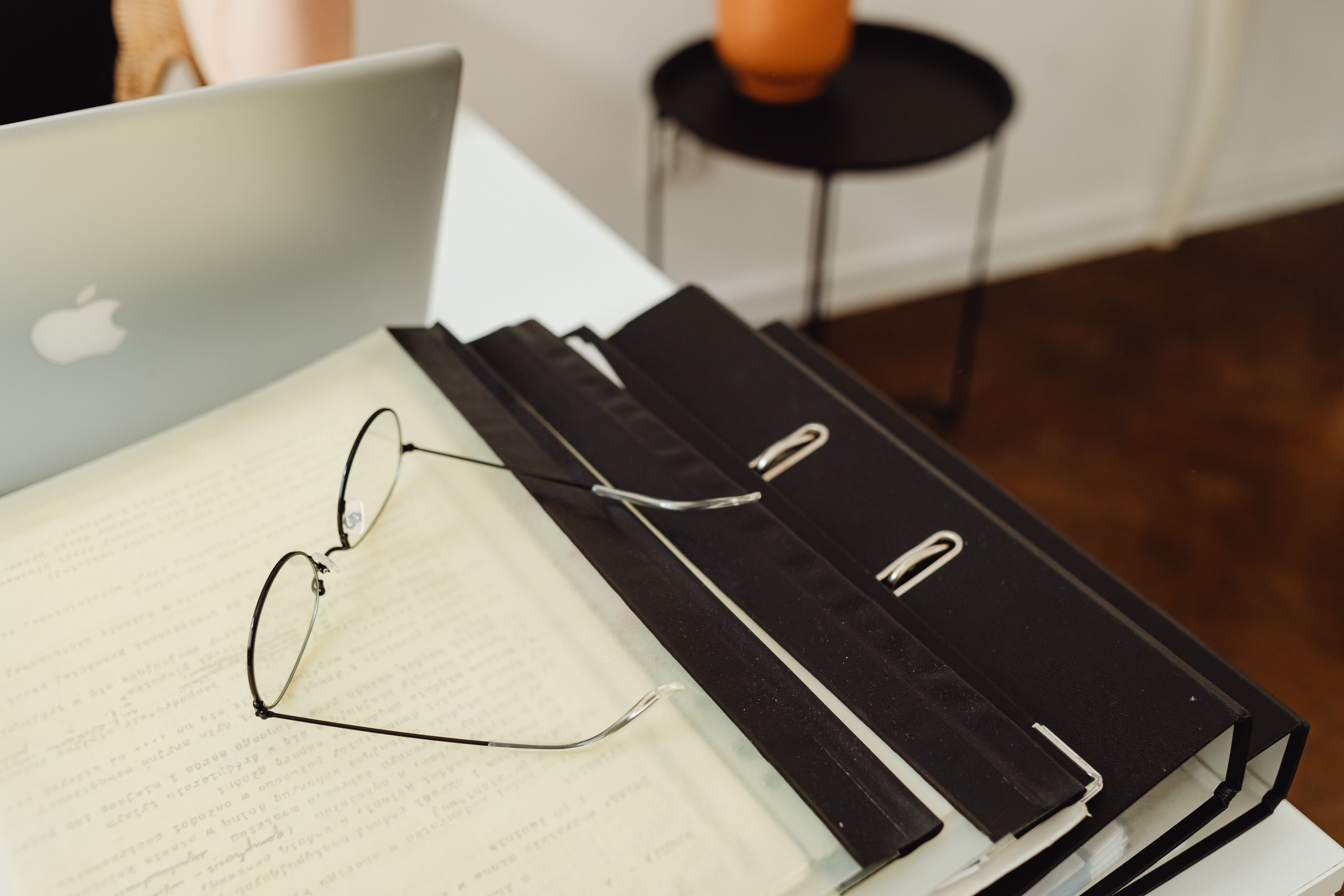 Binders and eyeglasses representing a structured data room