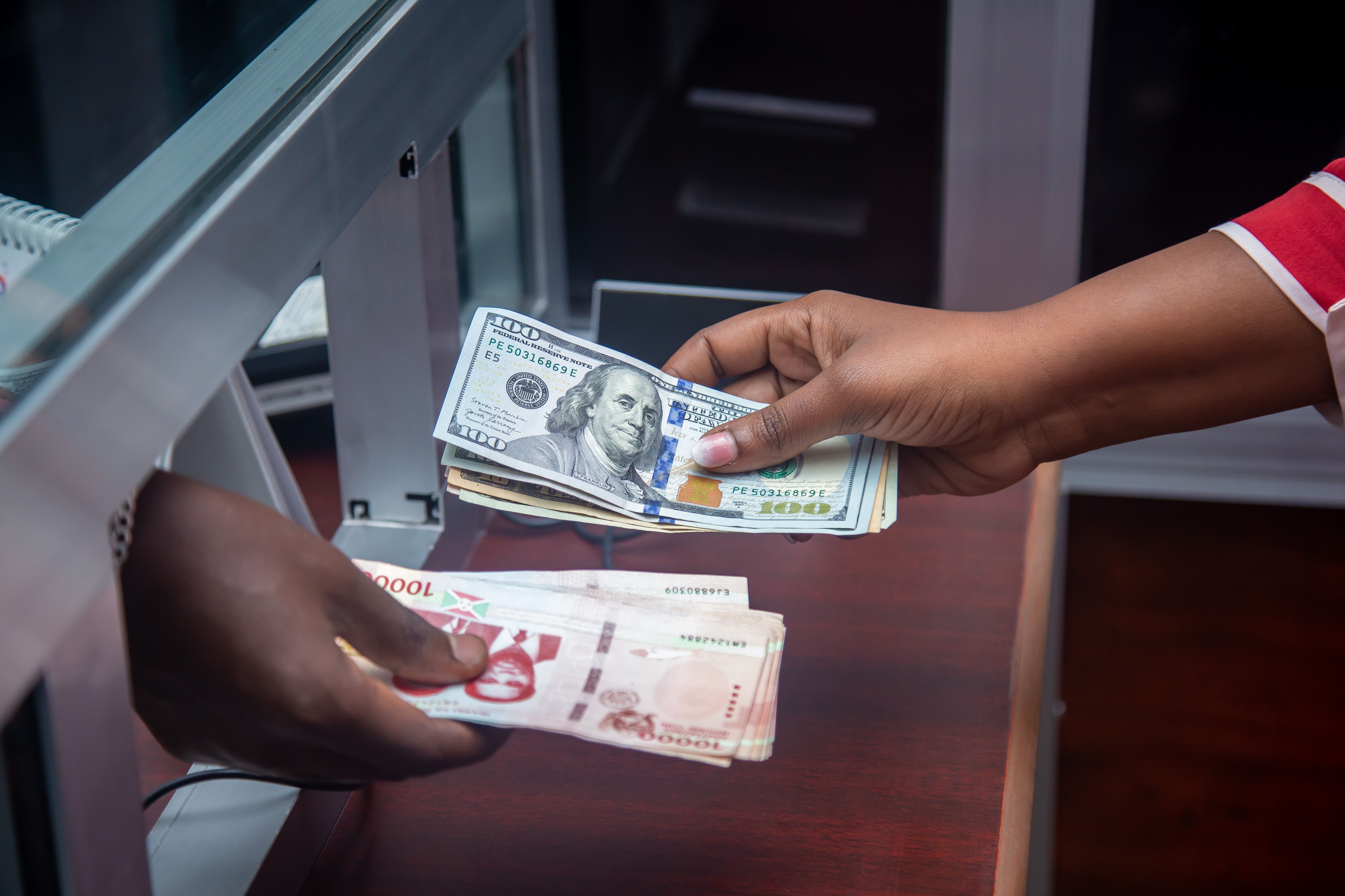 Currency exchange at a bank counter representing outward investment from Vietnam transfers