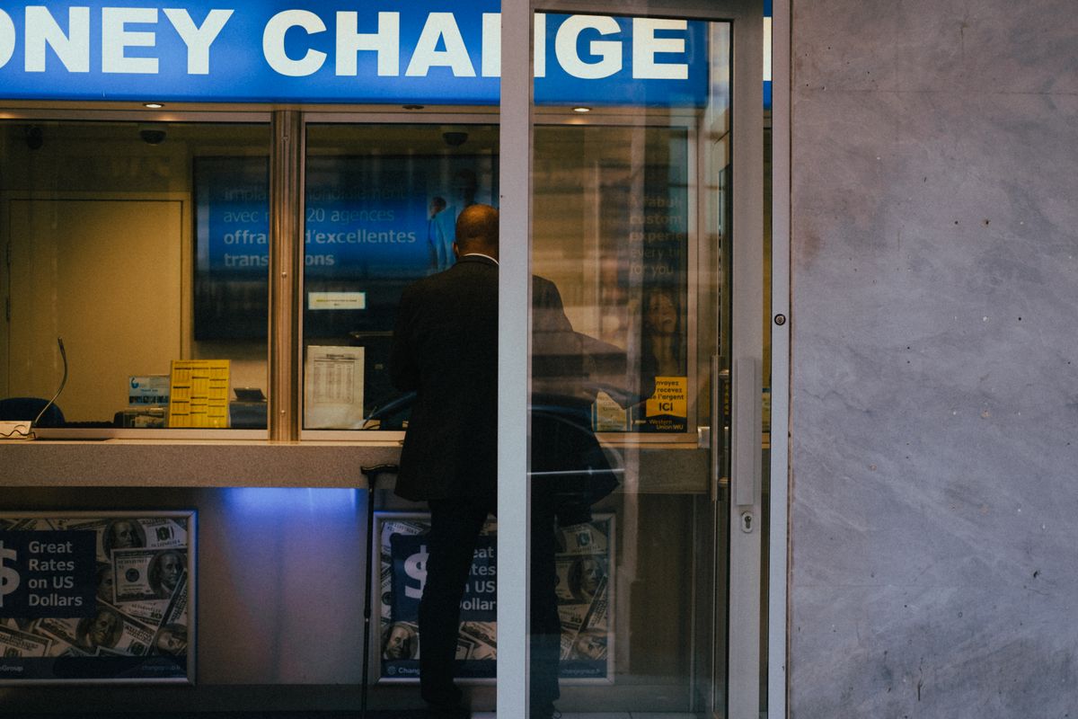 Currency exchange counter illustrating valuation for payment in an M&A deal