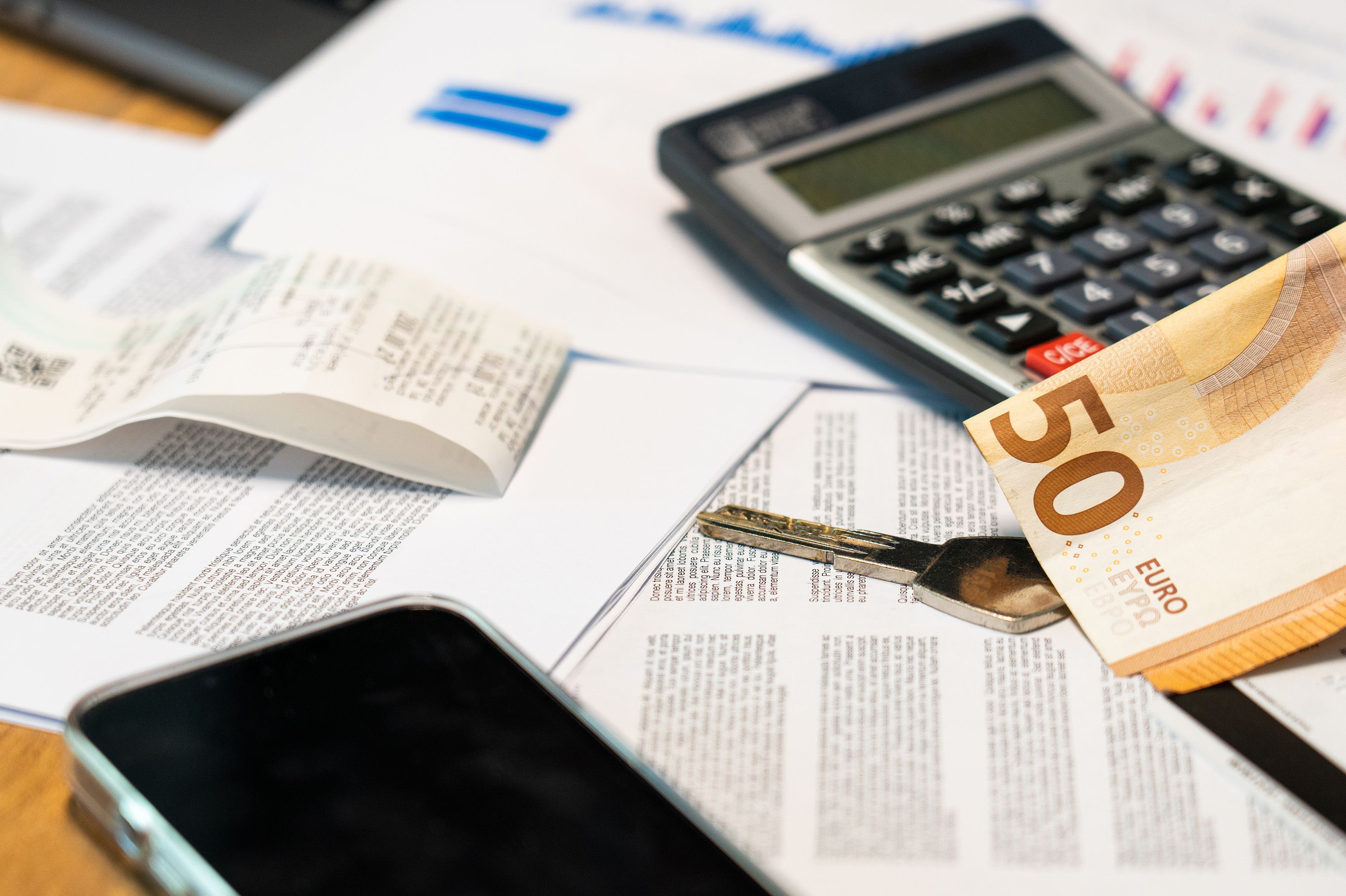 Currency and calculator illustrating cross-border purchase price payments