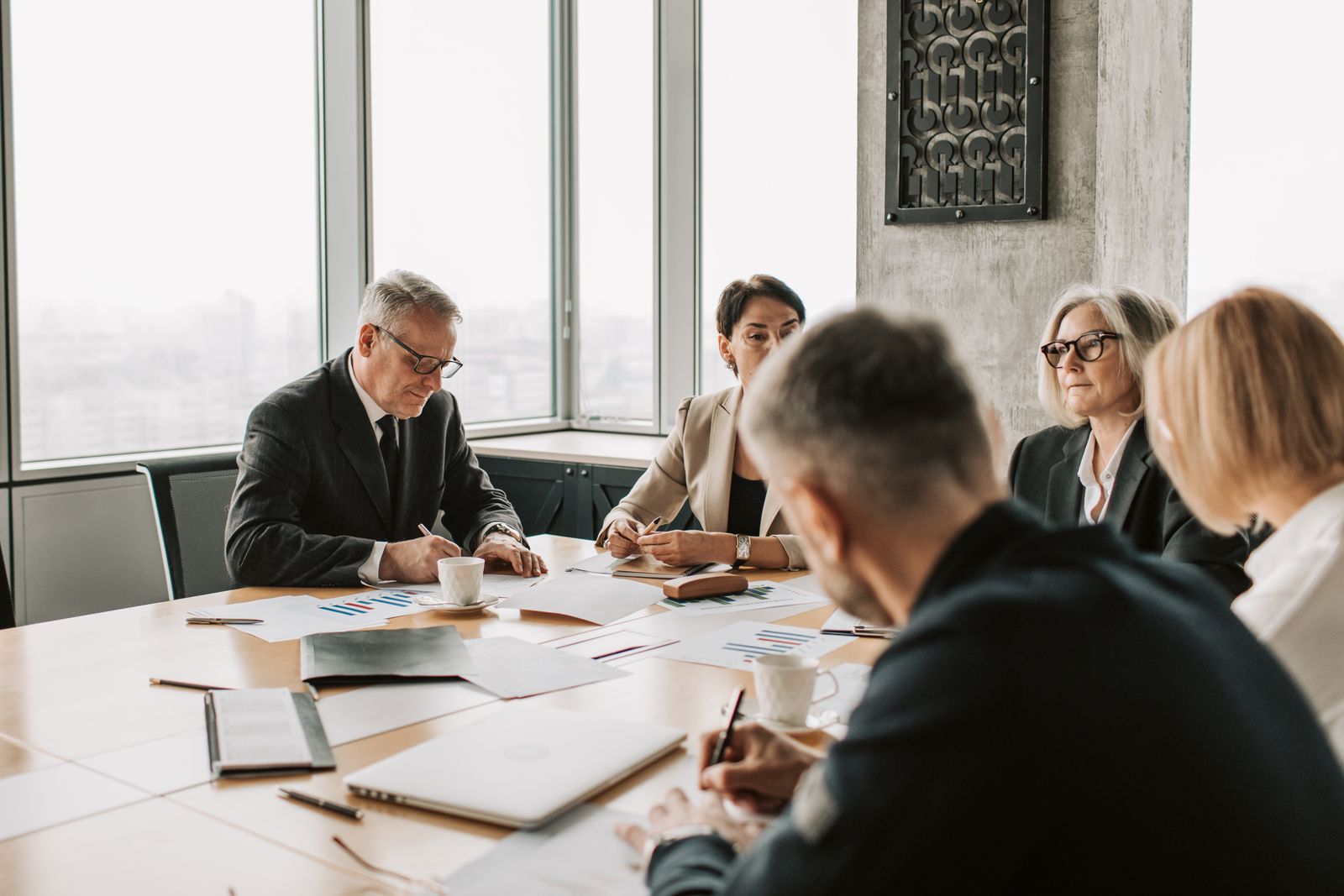Minority shareholders reviewing Tag-Along Rights clause during an M&A negotiation