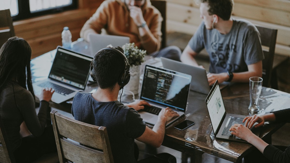 wholly foreign-owned enterprise – team working on laptops